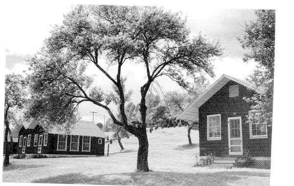 Higgs 7a.jpg - Cliffside cabins -- likely 7-8 to the left, 9-10 to the right. The path up to the dining hall is visible in the background.